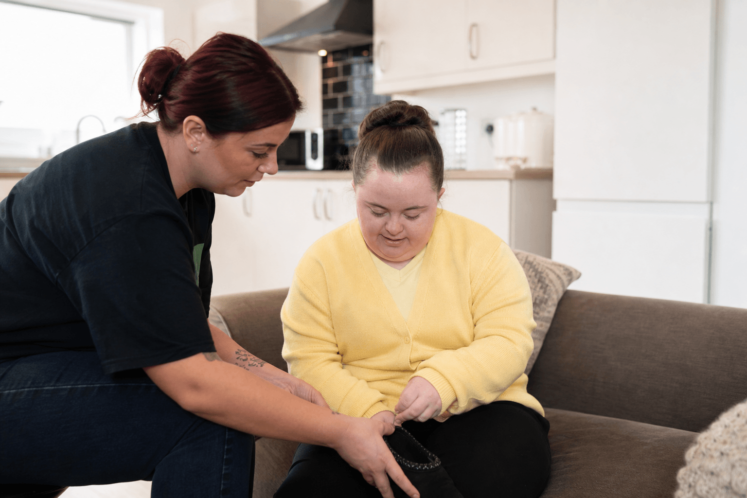 Care worker supporting a client in a UK supported living home