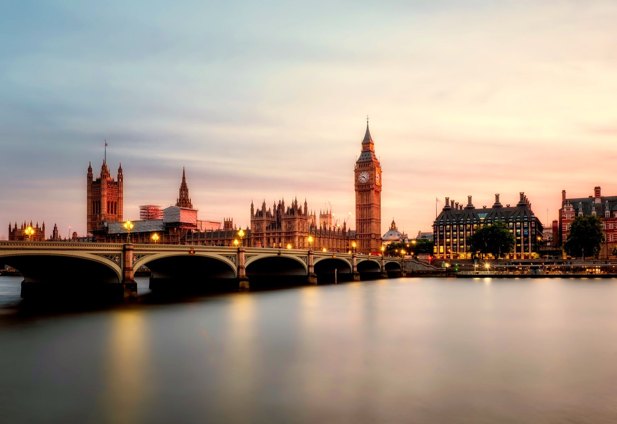 Tower Bridge and Big Ben at sunset along the River Thames, iconic London landmarks